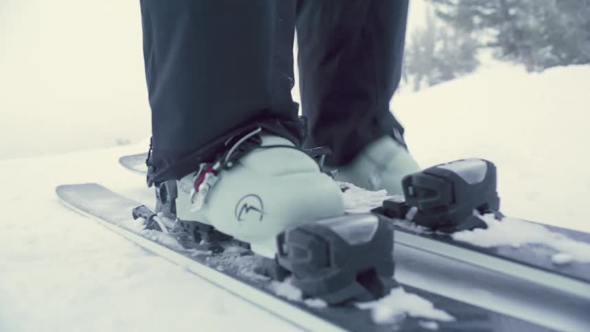 Person positioning their feet on a ski machine