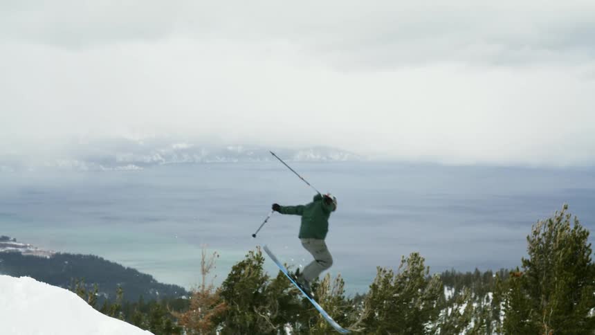 Person performing an aerial skiing maneuver in the mountains