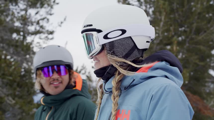 Three people in ski gear are on a snowy mountain