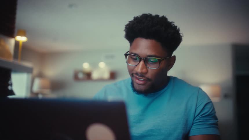 Man working while seated in front of a laptop