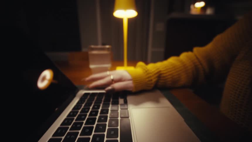 A woman typing on a laptop
