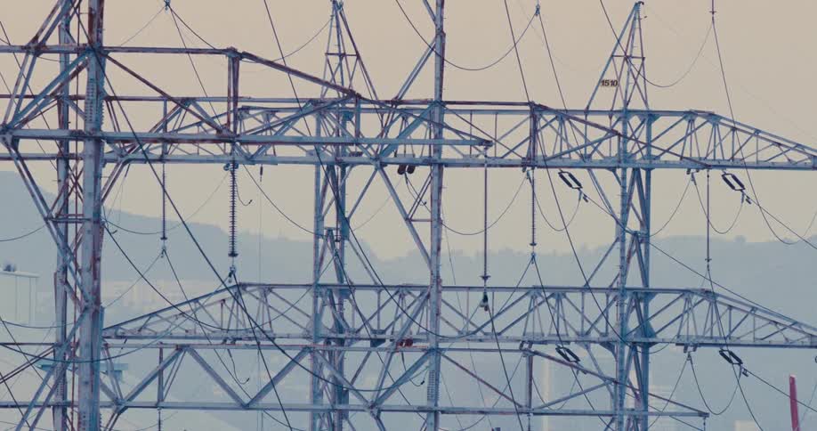 A large electricity transmission tower outdoors during daytime
