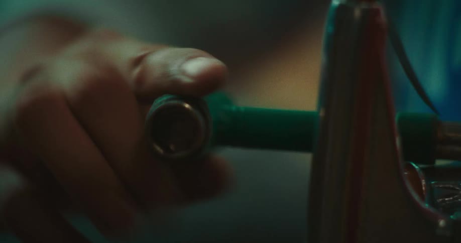 The mans hand is turning the tool