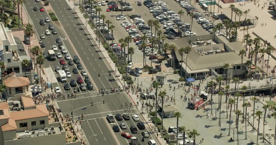 Aerial view of crowds of people walking across the street in Huntington Beach, California