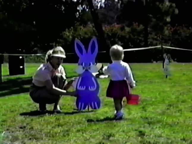 The child walks towards the cut out of an easter bunny