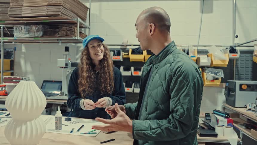 Two people working on building some things together