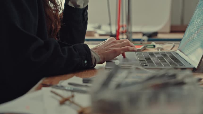 Closeup of a woman scrolling on a laptop trackpad