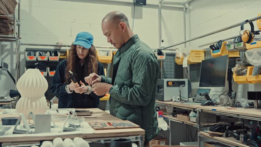 The coworkers are working on something at the bench