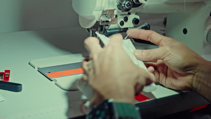 A person sewing in a factory