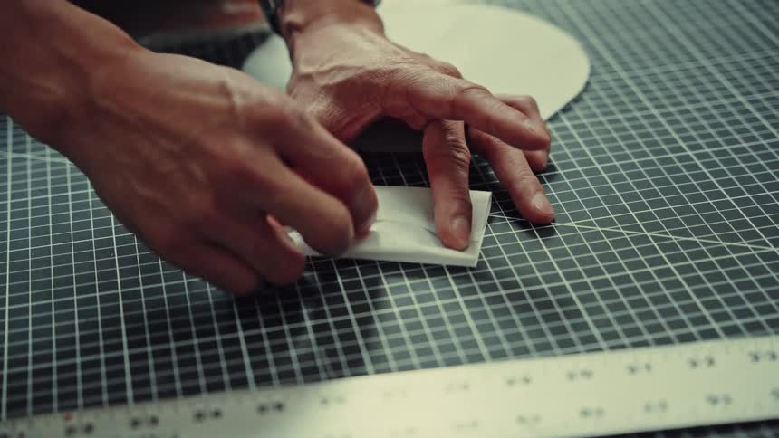 Individual adjusts a piece of fabric while in a craft room