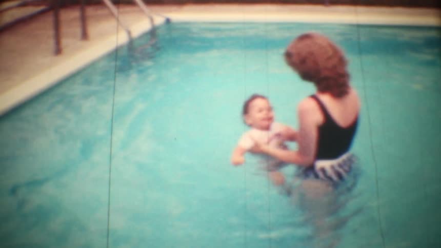 A mother and son playing in a pool