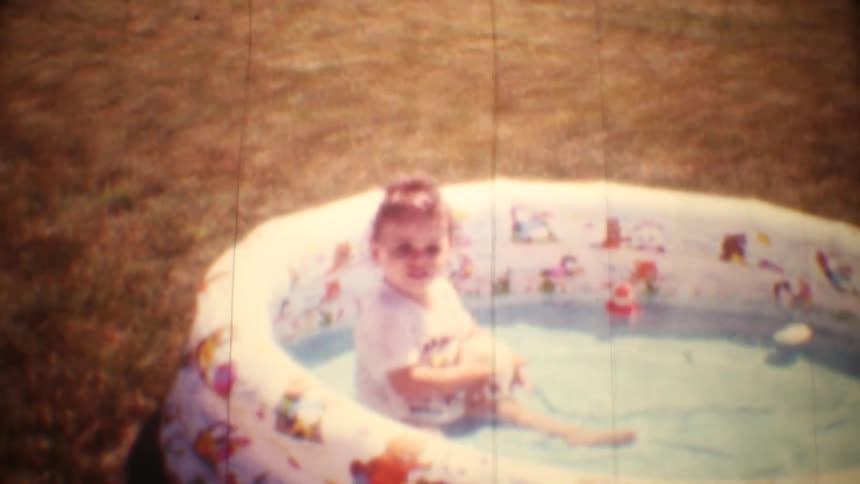 A mother and baby playing in a pool