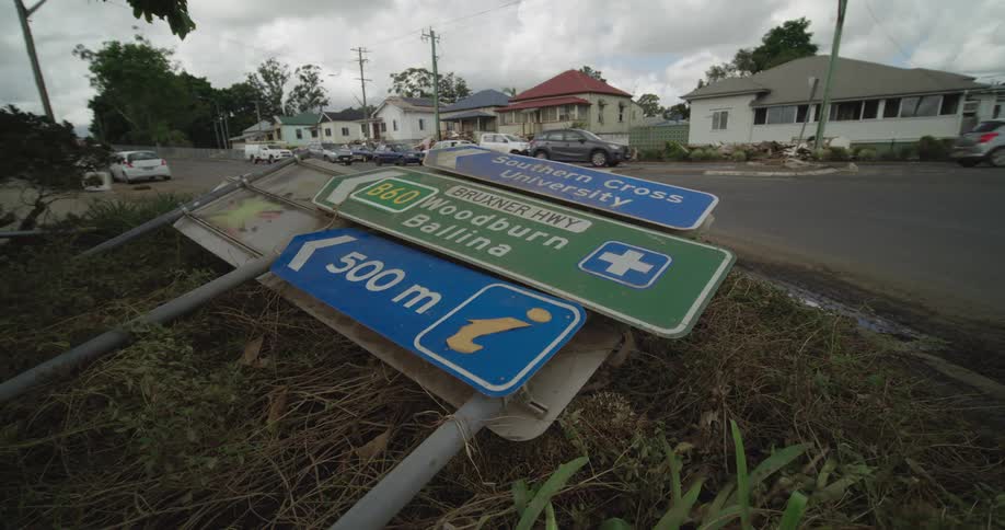 Road sign has fallen beside a street