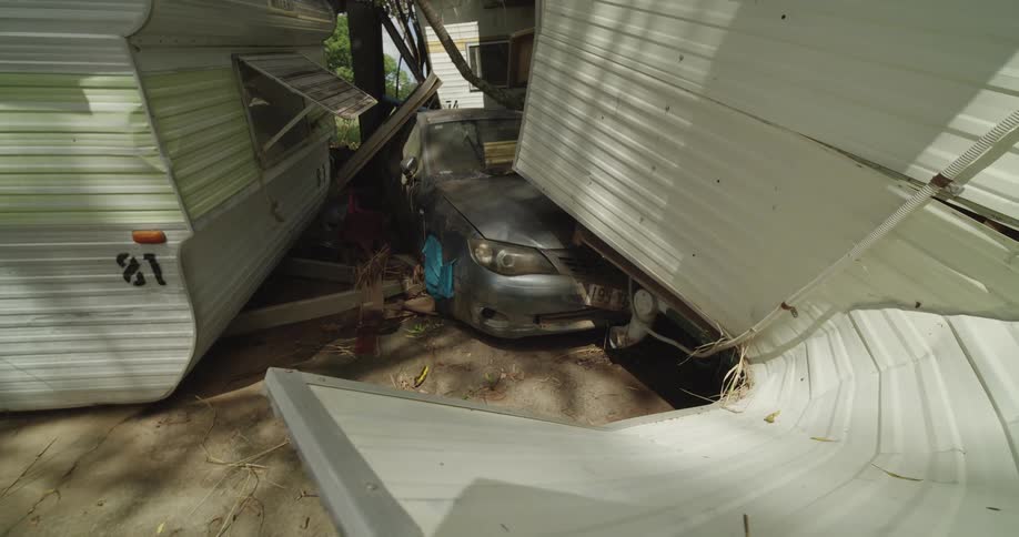 A car that was crushed by a metal building