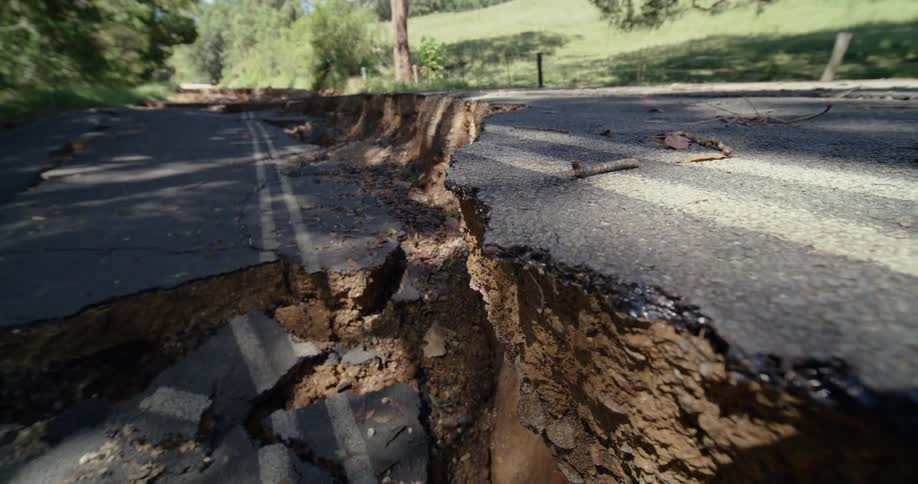 A large fissure in the middle of a road