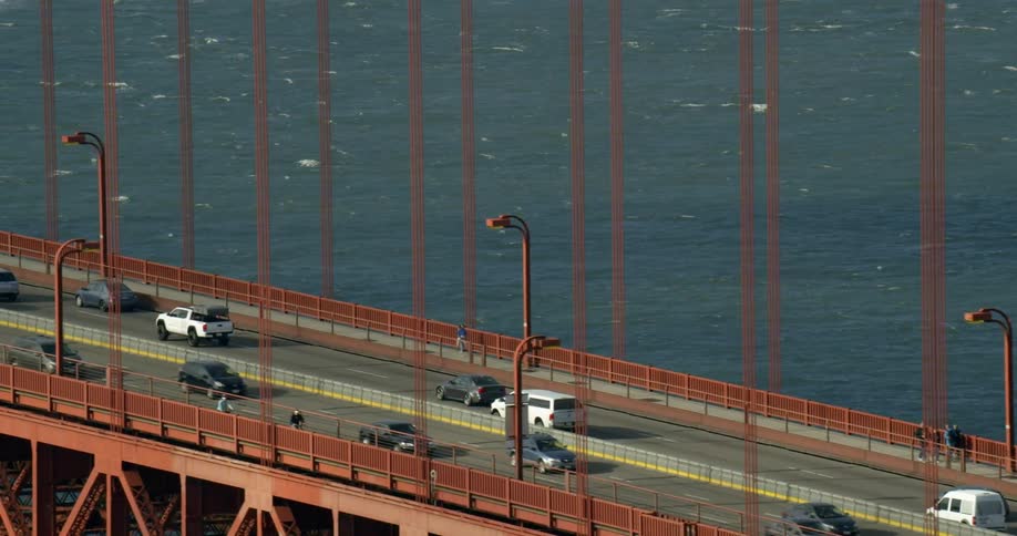 Cars are crossing the golden gate bridge on sunny day in San Francisco, California
