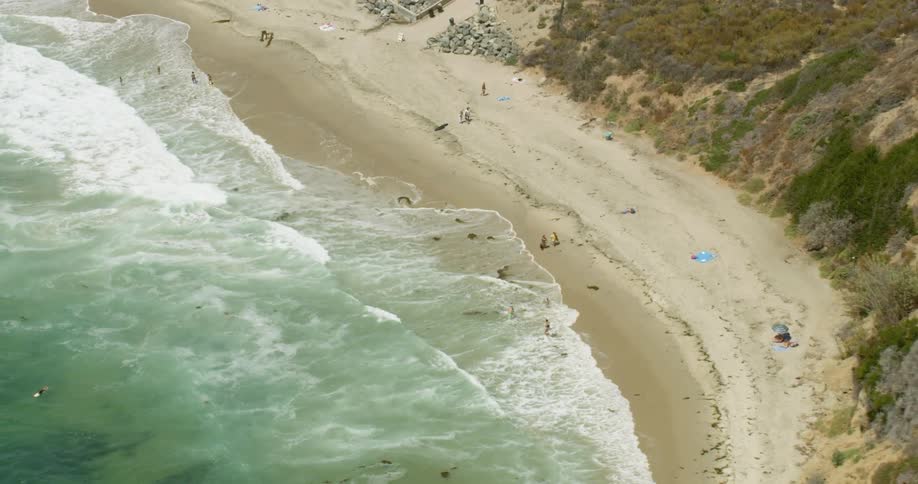 People on a large beach surrounded by mountains in San Diego, California