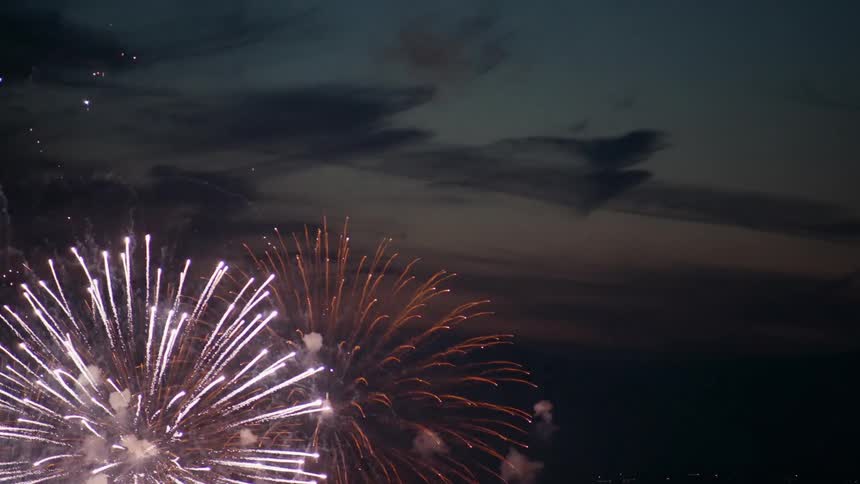 Fireworks over an urban area outdoors during dusk or dawn