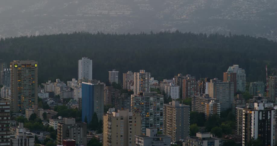 Panorama of metropolises with wooded mountains in the background