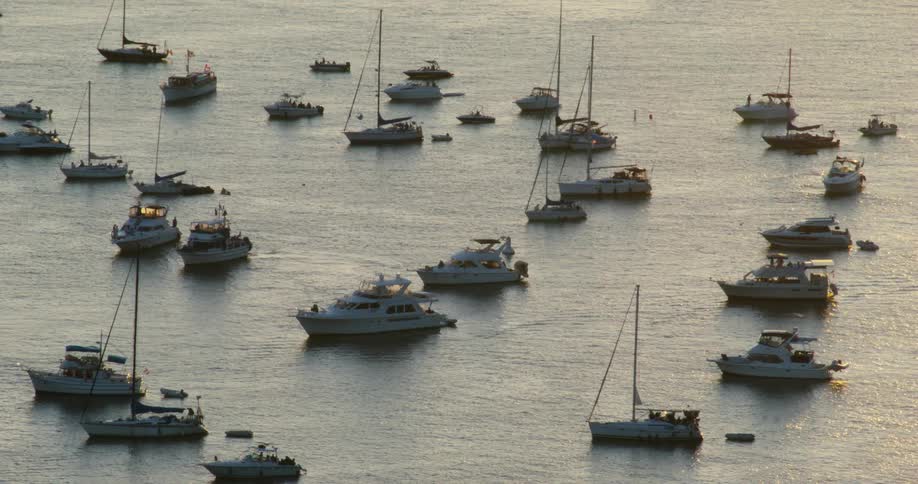 A fleet of boats floating in the ocean