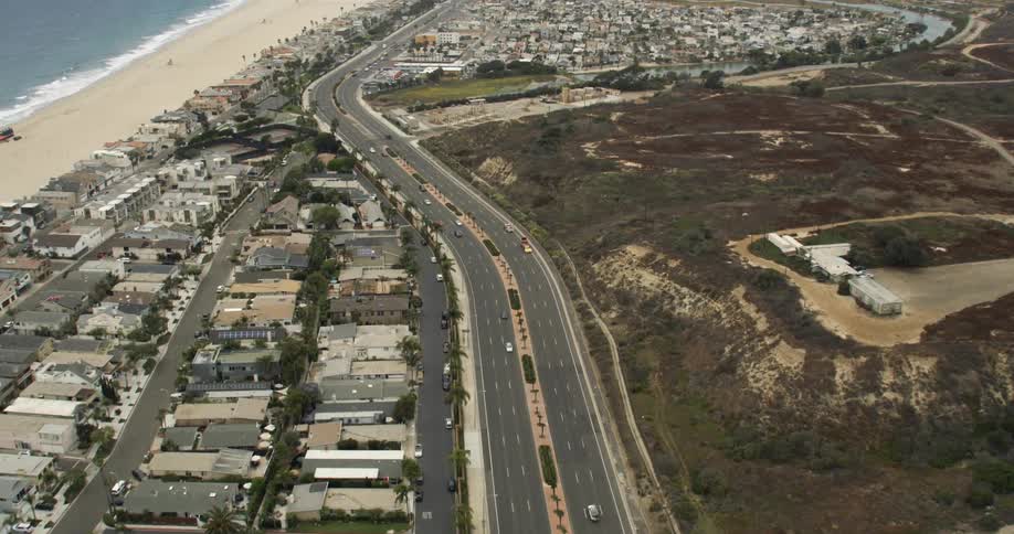 Cars drive down the PCH in Orange County, California