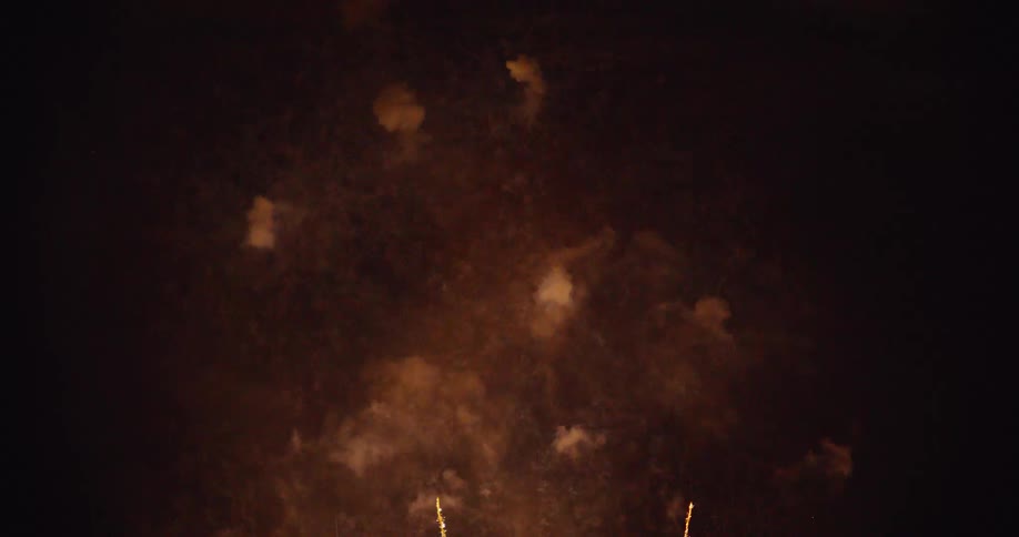 Colorful fireworks explode and glow as they spread across the night sky