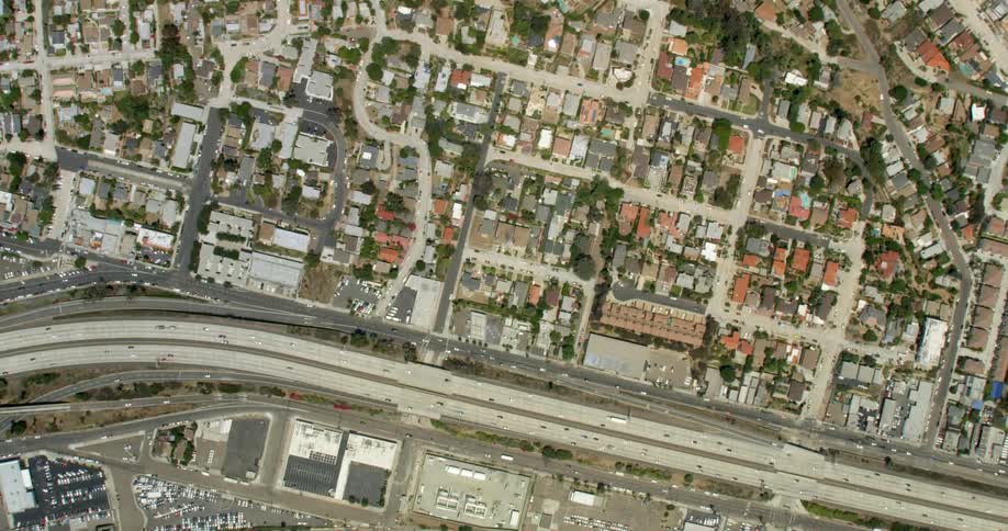 Cars traveling on busy freeway in the middle of city on sunny day in San Diego, California