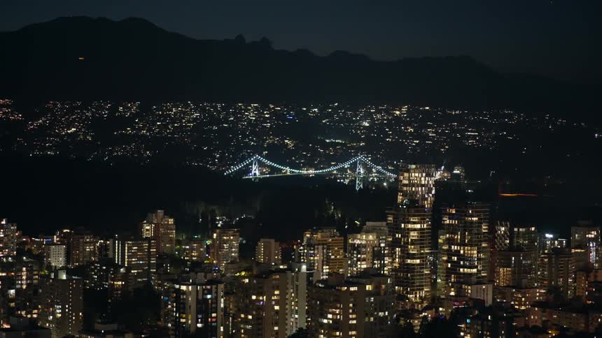 The bridge is lit up in the middle of the city