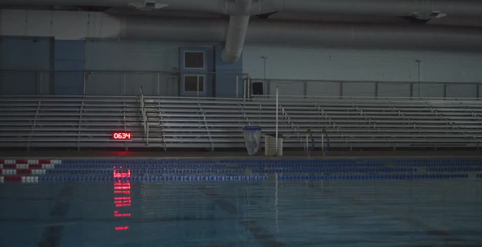 An indoor pool with a timer running near it