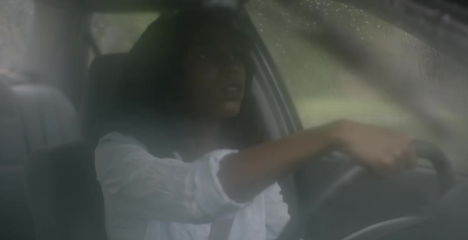 Woman driving in car on rainy day