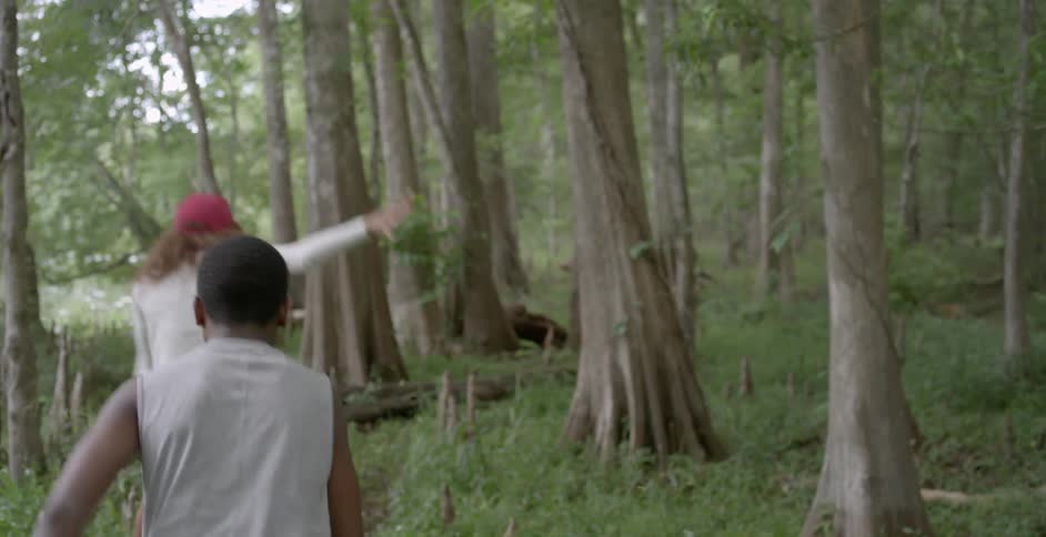 A woman and child are hiking in the woods