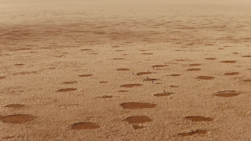 An aerial view of a desert with sand