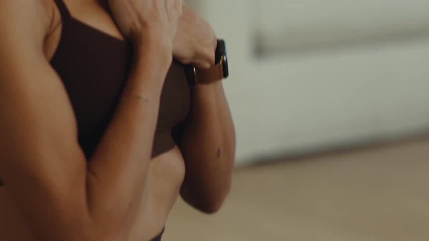 Adult woman on the floor putting her hands over her chest indoors during day time