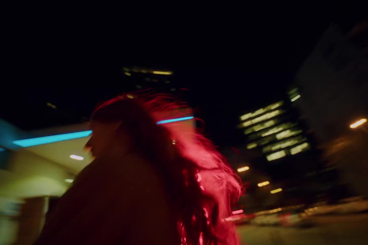 Woman walking through the city at night