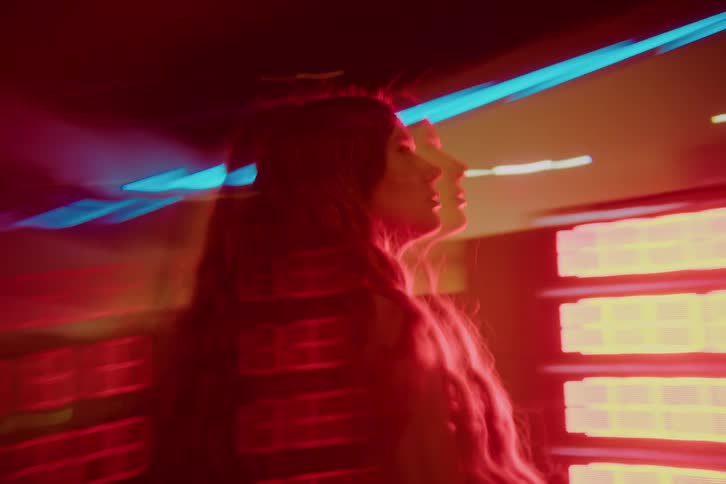 A woman standing outdoors at night