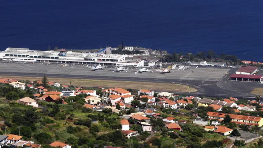 An aerial view of an airport along the water