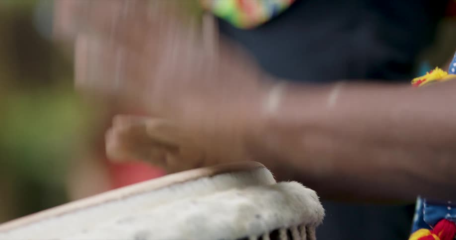 Pair of hands playing a drum musical instrument