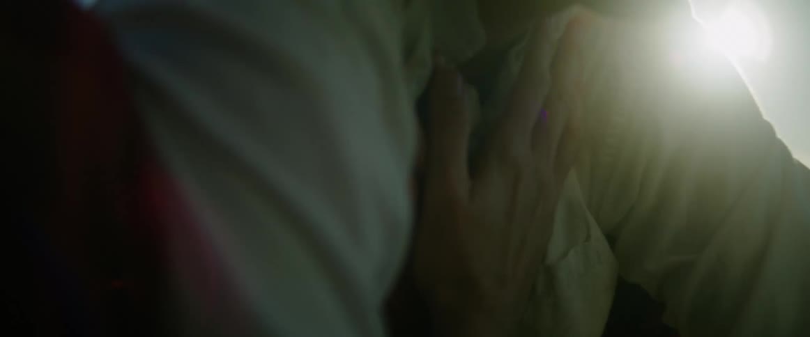 Person placing their palms on their own chest in a lakeside setting