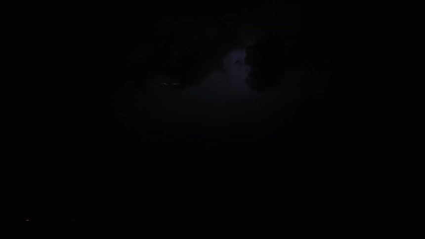 Branched lightning illuminating dense clouds above a fogcovered surface