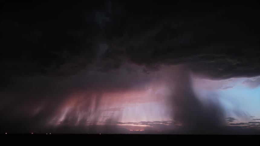 Thunder and lightning on dark clouds during a storm with tornadoes over a field outdoors during dusk or dawn
