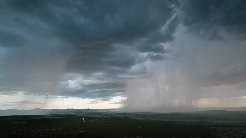 Dark clouds move across the sky as a super cell storm pours rain and lightning strikes