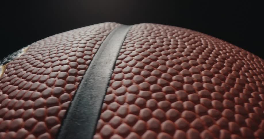 Textured surface of a basketball with embossed detail and visible seams