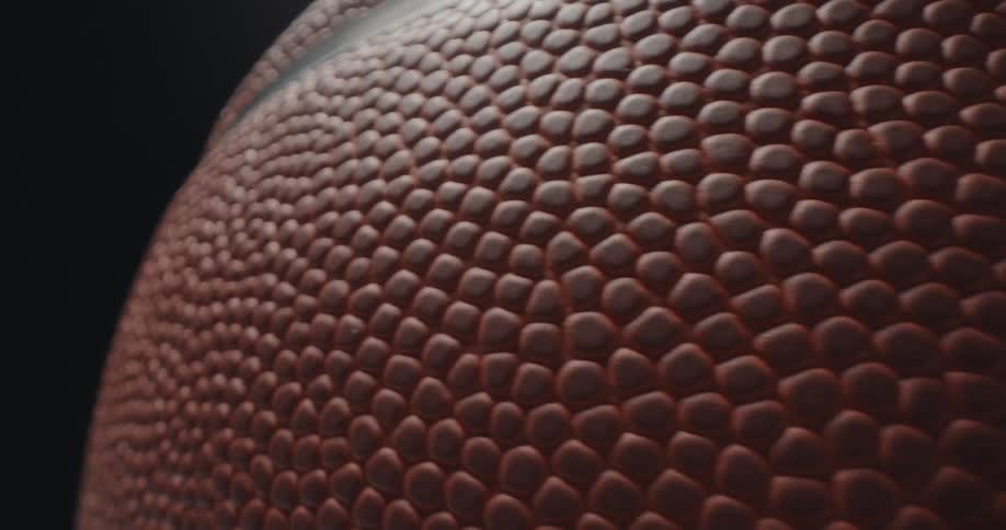 Spinning basketball in a dark room indoors