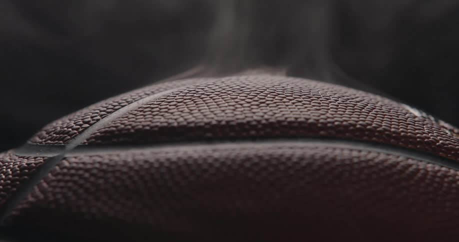 Basketball indoors in a dark room surrounded by smoke