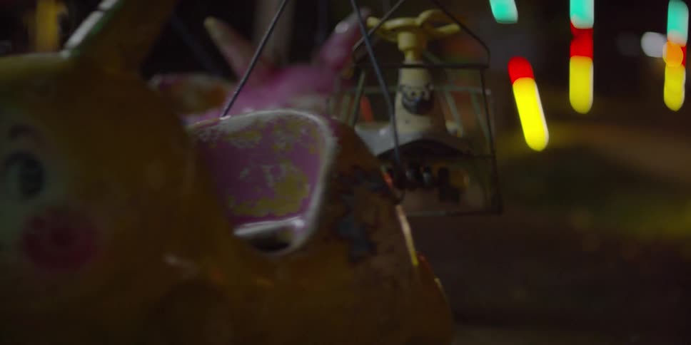 An amusement park ride is turning at night