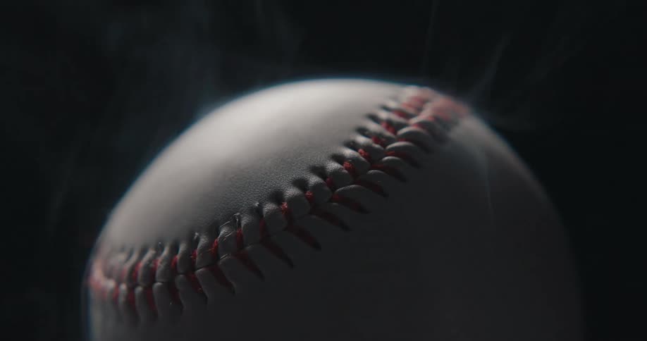 Baseball with red stitching enveloped in smoke