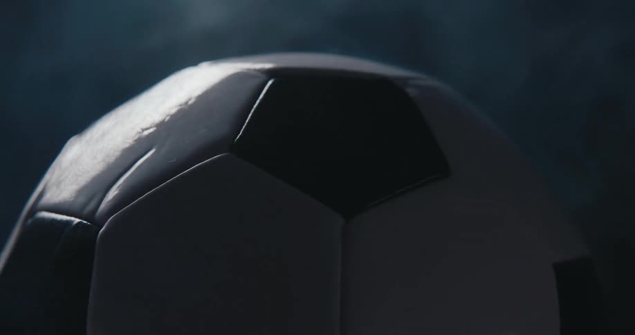 Black and white soccer ball highlights texture against smoky background