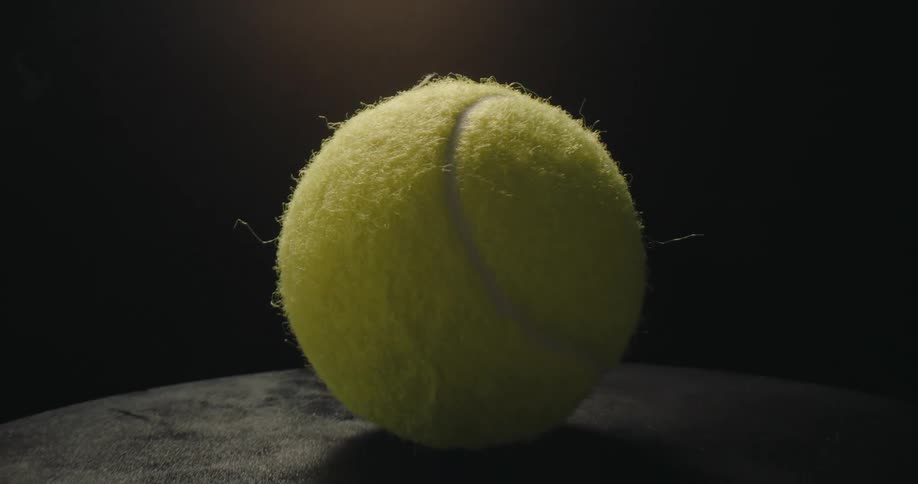 Green tennis ball on a surface