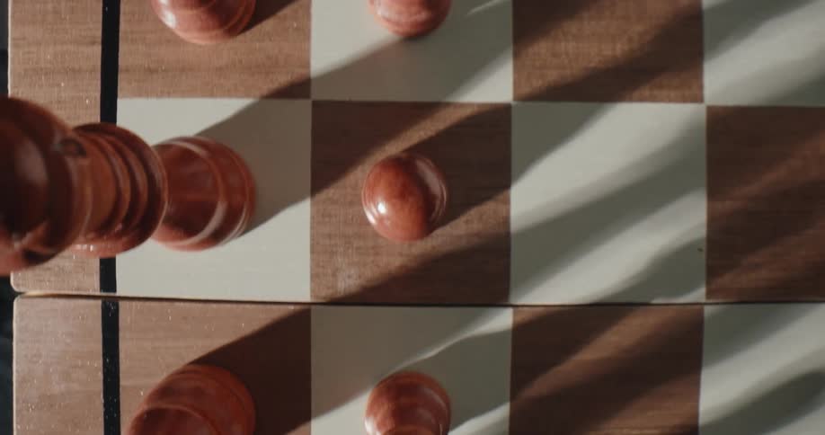 Chess pieces over a chessboard indoors during day time