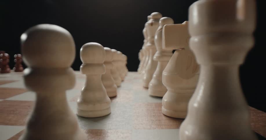 Chess pieces over a wooden chess board indoors